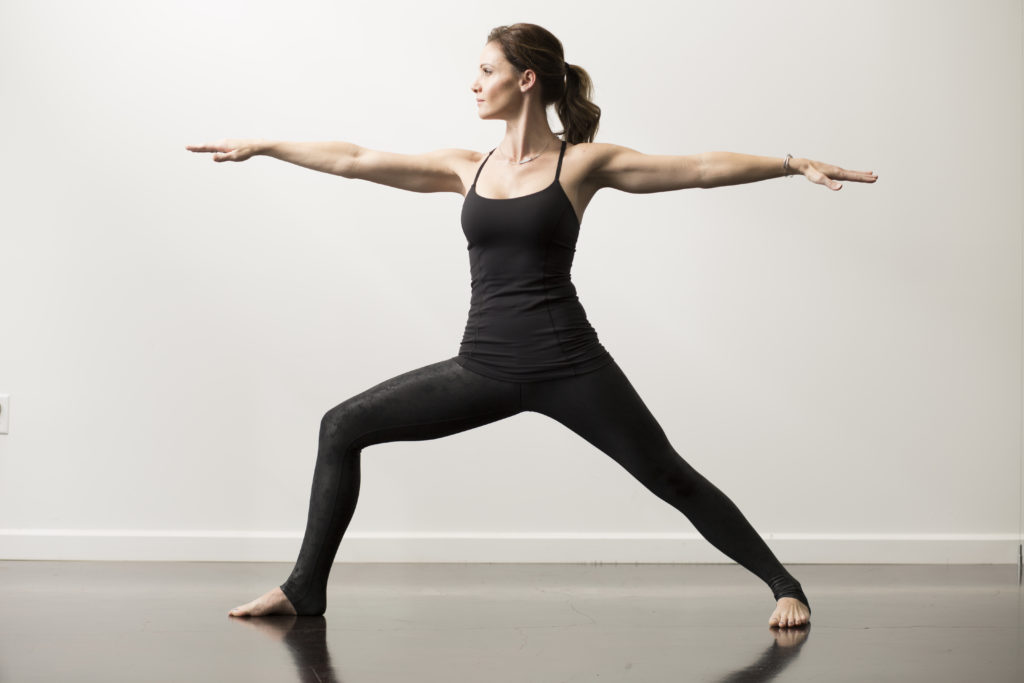 Premium Photo | Woman practicing yoga standing in variation of warrior 2  posture or virabhadrasana two pose
